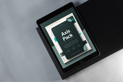 A tablet device displaying a digital design asset pack titled 'Axis Pack' on its screen, resting on a black surface against a gray background.