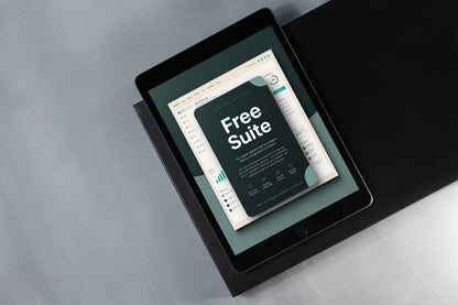 A tablet device angled on a dark surface, displaying a digital template or guide with the words 'Free Suite' on the screen.