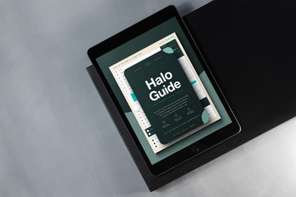 A tablet device angled on a dark surface, displaying a digital guide titled 'Halo Guide' with a dark teal and white design.