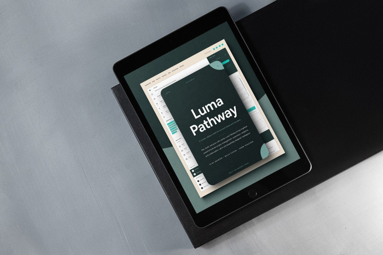 A black tablet device angled on a dark surface, displaying a digital cover titled 'Luma Pathway' with a dark teal, cream, and white design.